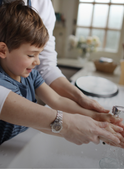 Boy washing his hands
